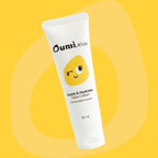 Oumi Kids calm & hydrate face cream tube on a yellow background